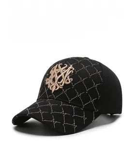 Detail of black baseball cap featuring quilted diamond patterns and golden 3D embroidery