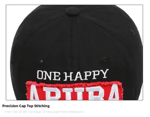 Detail of black cotton twill baseball cap with white embroidery and red raw-edge patch
