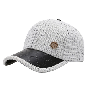 Classic black and white tweed baseball cap with black leather brim and golden R logo