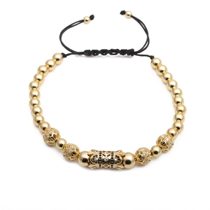Adjustable woven bracelet with gold beads and micro-pave cubic zirconia hollow spheres