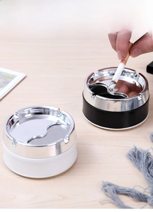 Detail showing smooth rounded edges and rotating silver metal lid of the round ash tray