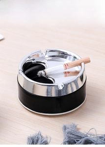 Detail of windproof stainless steel ashtray with U-shaped slots and rotating metal lid