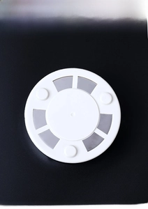 Detail view of the stainless steel ashtray base featuring three anti-slip rubber feet