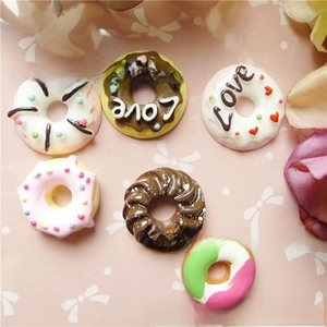 Close-up of 6 assorted resin donut charms with Love lettering and heart details