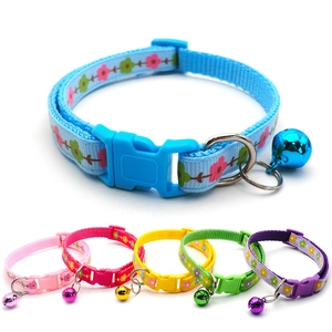 Detail view of colorful nylon pet collars with flower patterns and metal bells in six colors