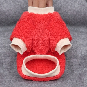 Detail of red thick fleece dog sweater showing soft coral velvet texture and ribbed edges