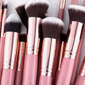 Detailed macro view of soft gradient fiber bristles and rose gold ferrule on makeup brushes