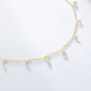 Macro view of dainty S925 silver gold-plated choker with sparkling zircon settings