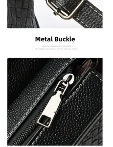 Detail of silver metal adjustable buckle and zipper on black crocodile texture handbag