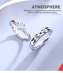 Macro shot of S925 silver crown ring with blue gemstone and heart pattern band