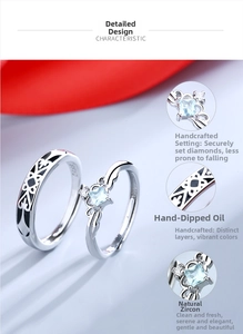 Detail view of S925 silver couple rings showing blue zircon inlay and totem oil drip craft