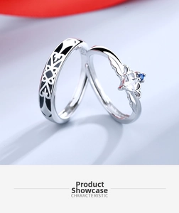 Detail of silver couple rings featuring a crown crown design and black enamel pattern