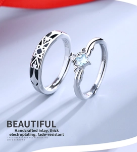 Detailed macro view of S925 silver couple rings featuring blue zircon and S925 hallmark