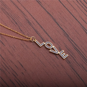 Golden LOVE letter pendant necklace with micro-paved blue zircons on wood texture