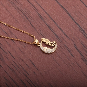Golden crescent moon necklace with winged angel pendant and sparkling cubic zirconia crystals