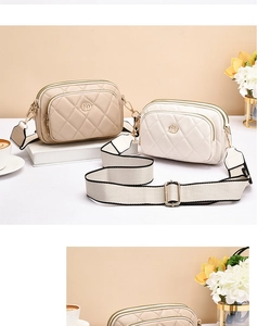 Detail showing high-quality quilted leather texture and golden metal logo on shoulder bags