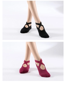 Detail showing cross-strap design of cotton yoga socks in black and burgundy colors
