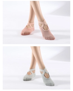 Pink and light grey yoga socks featuring non-slip grip soles and elegant cross straps