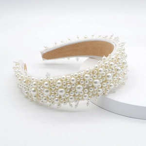 Detailed view of white baroque pearls clustered on headband with soft suede lining