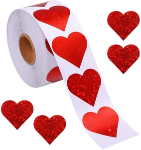 Detail of red laser holographic heart stickers roll for Valentine gift wrapping decoration
