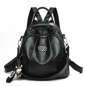 Fashionable black faux leather backpack with heart metal logo and cute cow charm accessory