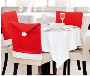 Set of four red Santa hat chair covers decorating backrests in a festive dining setting