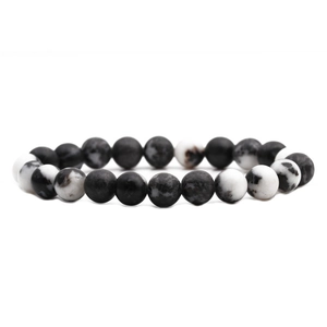 Macro view of 8mm black and white natural stone beads with smooth ink texture