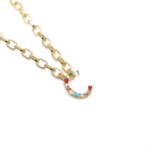 Close-up of golden letter C pendant necklace with vibrant multi-color zircon stones