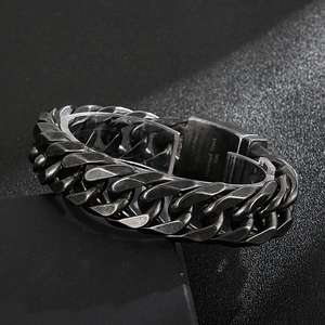 Detail shot of the engraved 316L stainless steel clasp on a vintage black Cuban chain