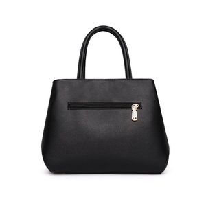 Chic black leather tote bag with embroidery and gold zipper detail shown on white background