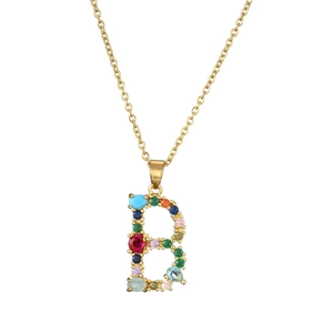 Detailed view of golden letter B pendant set with multi-color gemstones on a fine chain
