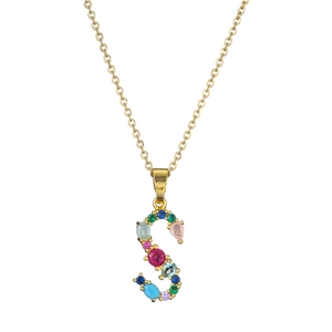 Detail of a gold letter S necklace pendant set with colorful vibrant gemstones