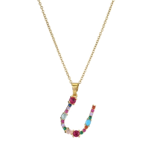 Close-up of golden letter U necklace pendant set with vibrant multi-colored gemstones