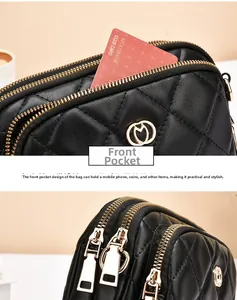 Detailed view of black quilted crossbody bag showing dual zippers and front slip pocket