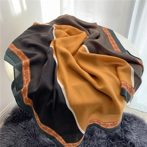 Detailed view of soft linen scarf with letter H pattern and colorful patchwork design