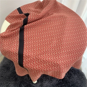 Detail of red and beige geometric pattern on soft cotton-feel oversized scarf shawl