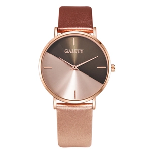 Detailed macro view of the rose gold and dark brown dial on a minimalist quartz watch