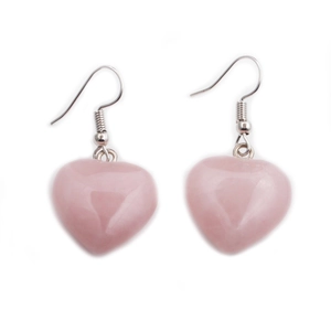Close-up of heart-shaped pink crystal earrings with silver fishhook ear wires