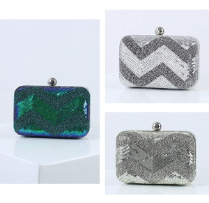 Detailed view of sequin clutch bags featuring wavy patterns in silver, gold, and green