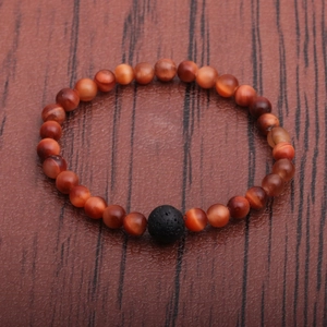 Tiger eye and lava stone beaded bracelet for men on a dark wood texture background