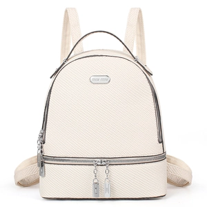Close-up of cream woven backpack featuring dual silver zippers and logo details