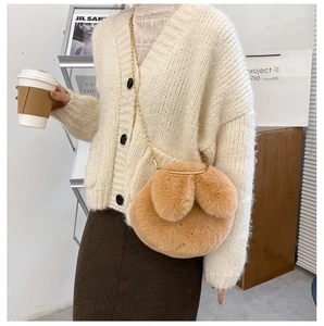Close-up of a soft plush rabbit-shaped crossbody bag with gold chain and floppy ears