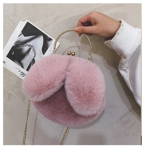 Detailed macro view of pink faux fur texture and vintage metal kiss-lock on a handbag