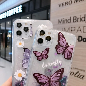 Detail of clear iPhone case with purple butterflies, white daisies, and sparkling liquid glitter