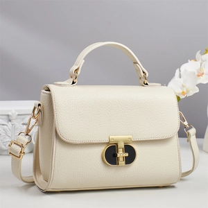 Elegant cream leather handbag with gold T-bar twist lock and detachable shoulder strap