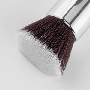 Macro shot of high-density flat top foundation brush with soft dual-tone synthetic bristles