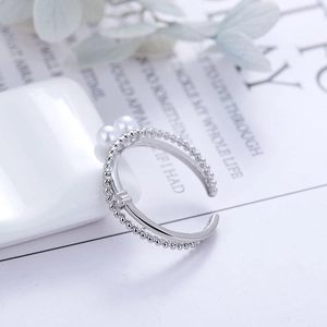 Adjustable silver layered ring with round white pearls, zircon accents and bead texture