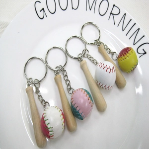 Detailed set of 4 mini baseball bat keychains with colorful balls in a white tray