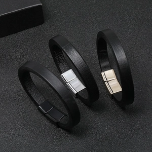 Close-up of black leather bracelets featuring black silver and gold magnetic buckles