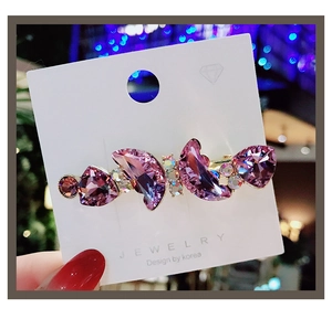 Detail of Korean hair clip with purple crystal hearts and rhinestones on display card
